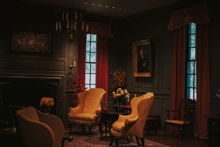 Elegant living room with yellow armchairs and fireplace.